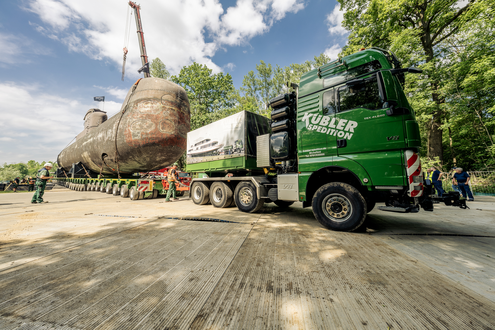 On a 30-axle vehicle, the colossus moved millimetre by millimetre towards solid ground.